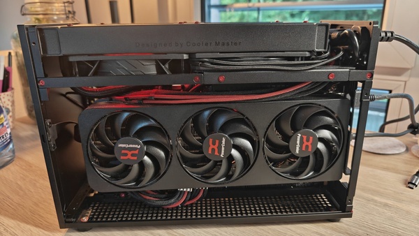 Triple-fan GPU from below, red-sleeved cables